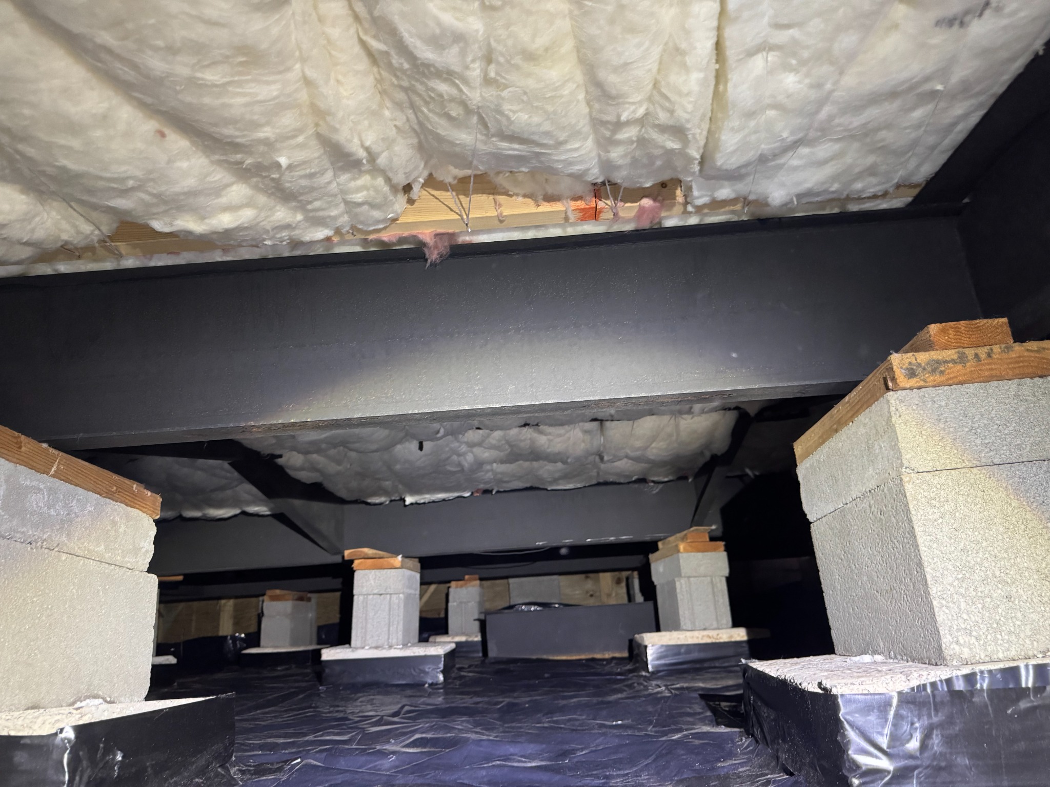 Pink batt insulation installed in a crawl space
